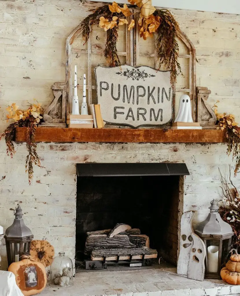 Rustic brick fireplace with autumn decorations pumpkins candles wheat garlands