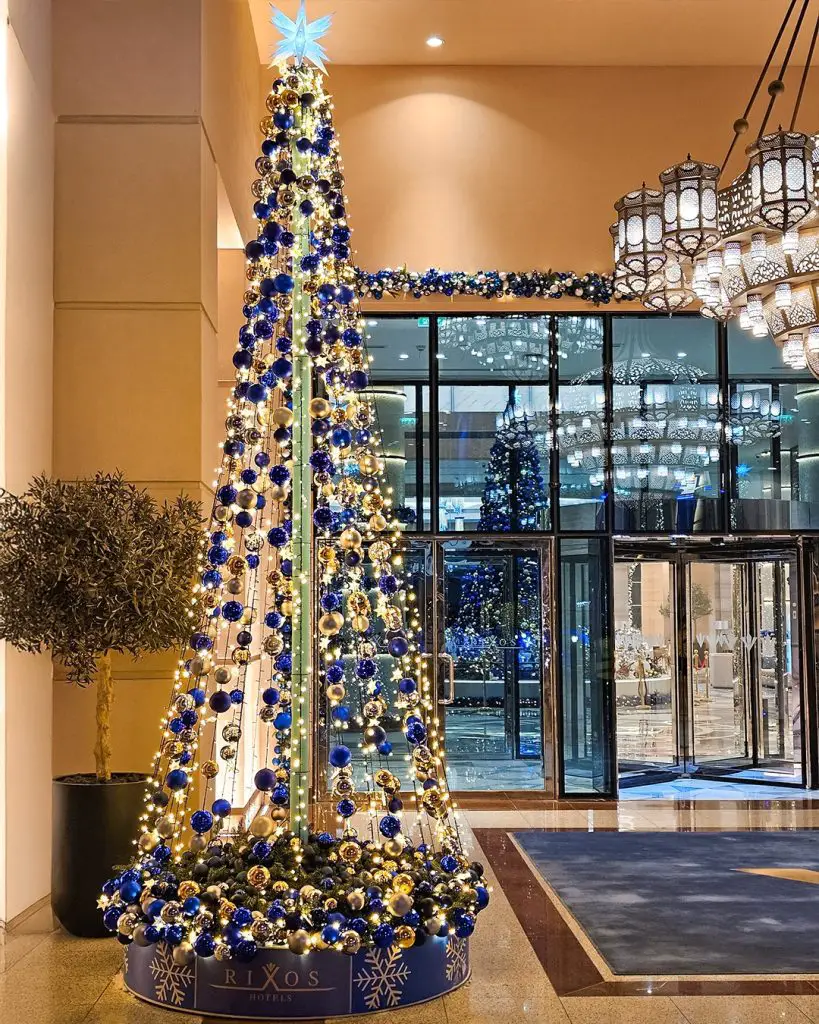 Grand hotel lobby blue gold Christmas tree display