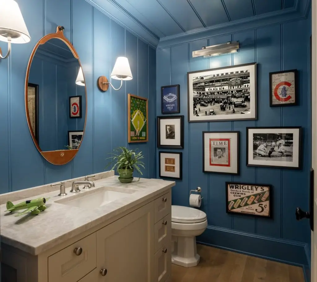 Blue paneled bathroom with vintage gallery wall