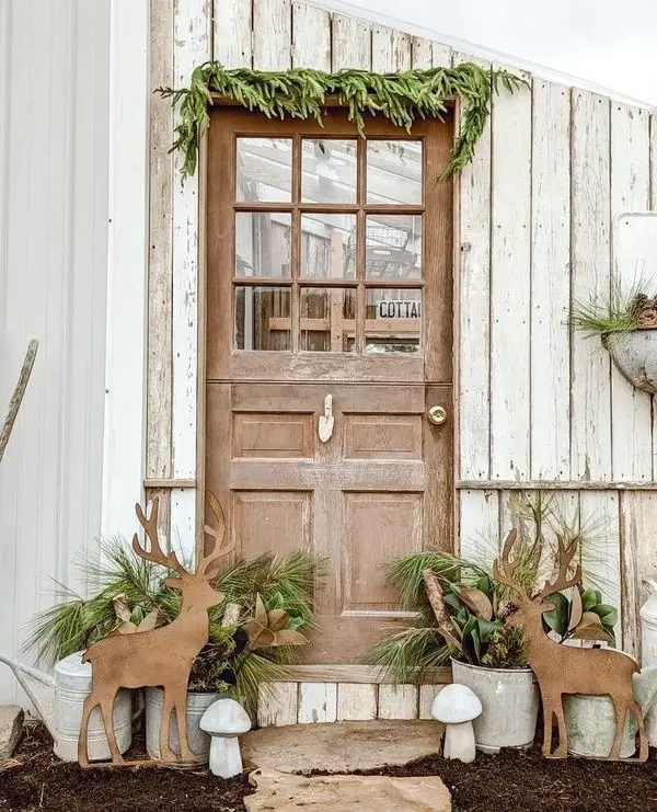 Cottage door with cedar garland wooden deer galvanized planter