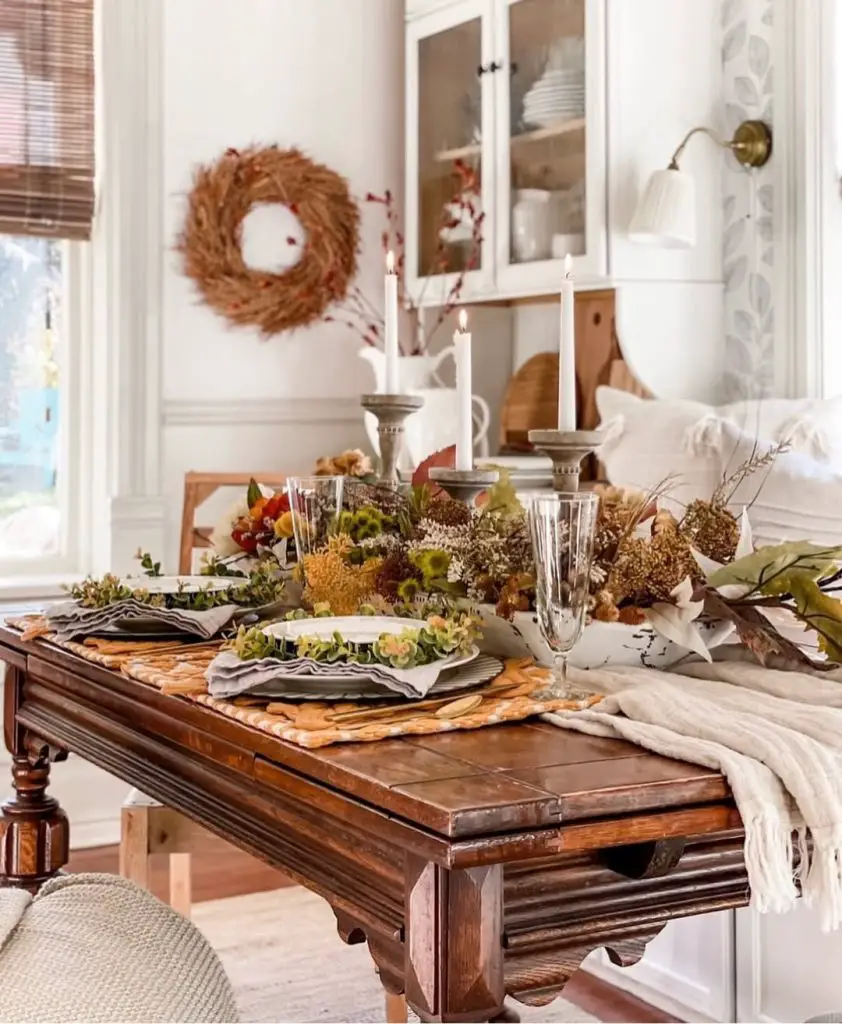 Elegant dining table with autumn flowers candles crystal glasses seasonal centerpiece