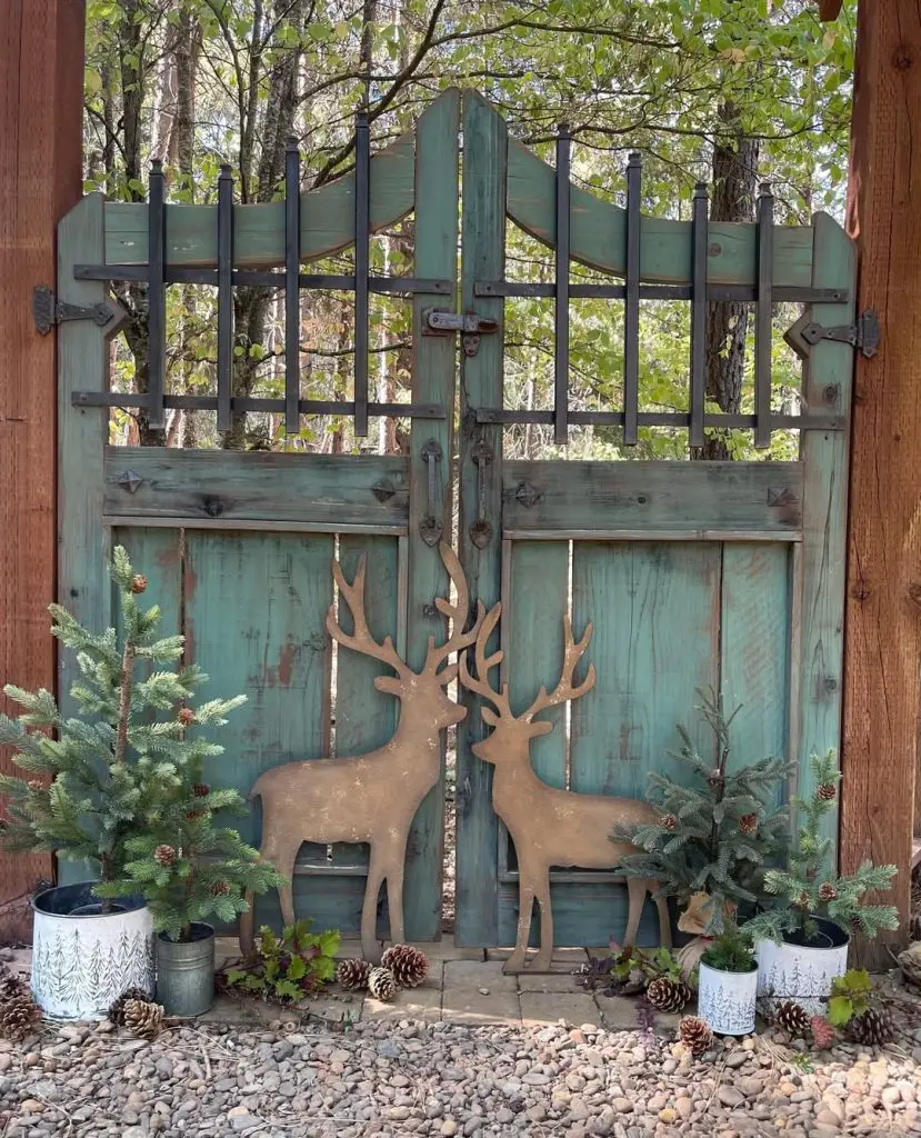 Turquoise wooden gate with deer cutouts evergreen decorations