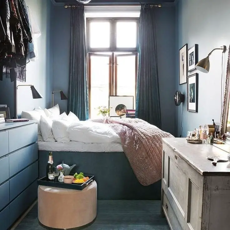 Narrow blue bedroom with built-in storage solutions