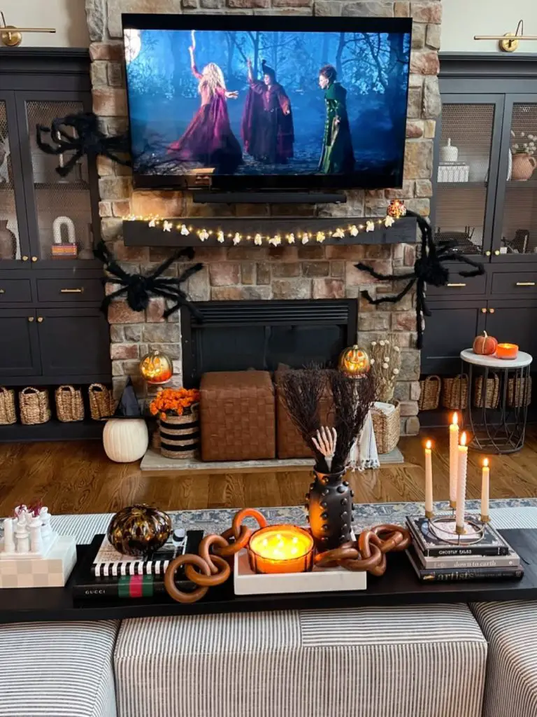 Dark entertainment center decorated with Halloween pumpkins and spooky decorations