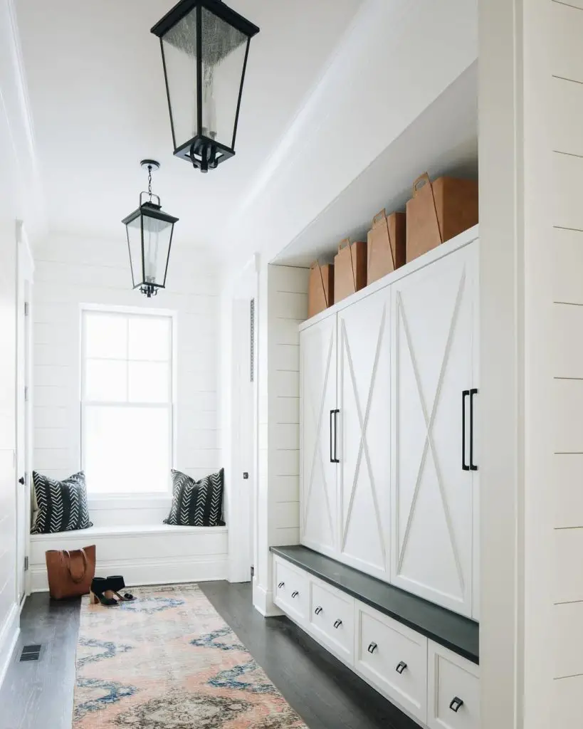 Long farmhouse mudroom with barn doors and pendant lights