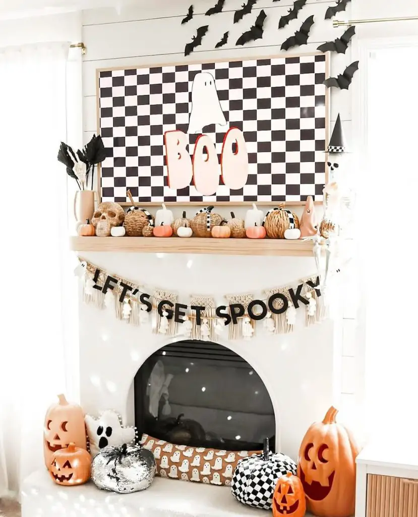 Fun Halloween mantel with BOO sign checkered patterns and orange pumpkins