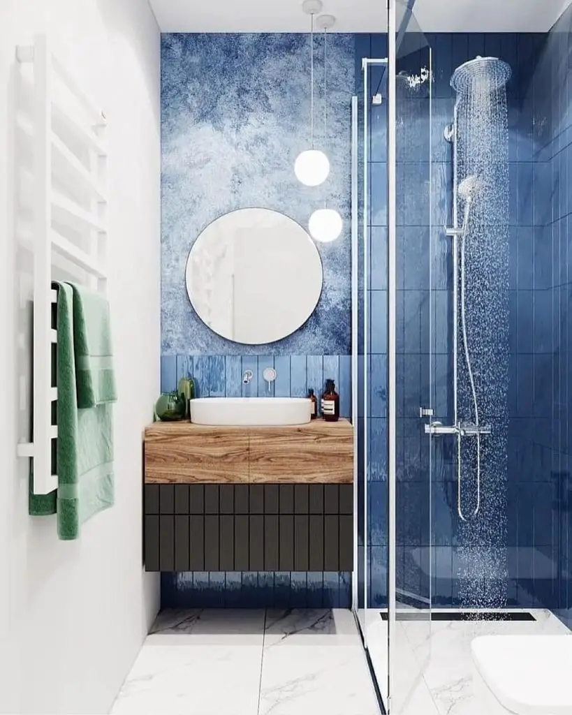 Blue textured bathroom with wood vanity accents