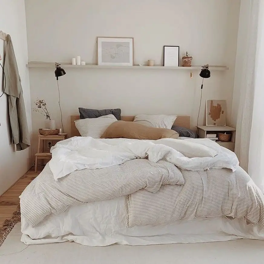 Neutral bedroom with floating shelf and warm lighting