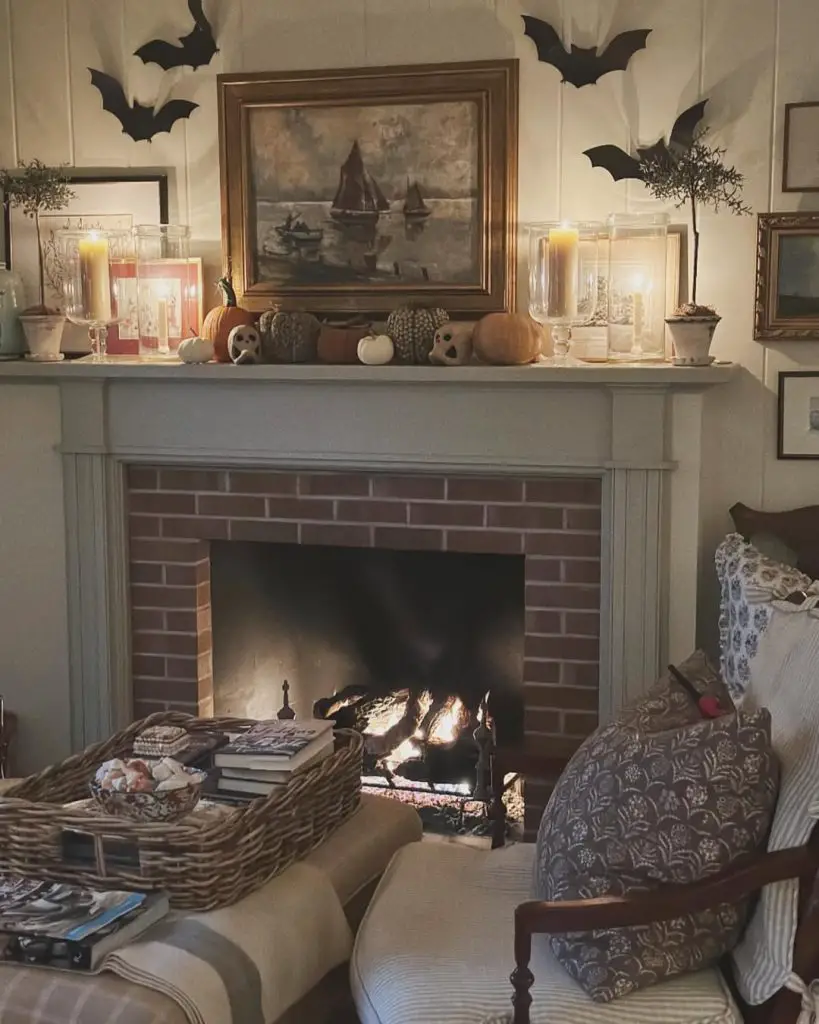 Cozy fireplace decorated with Halloween bats pumpkins and warm candles