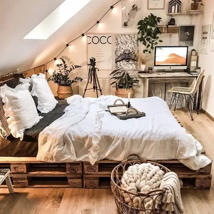 Rustic pallet bed with plants and string lighting