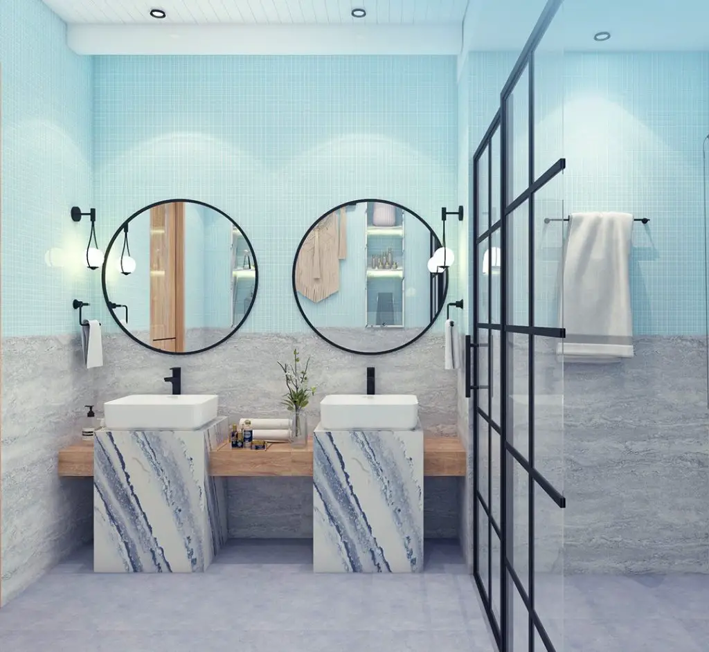 Blue bathroom with double vanity and marble accents