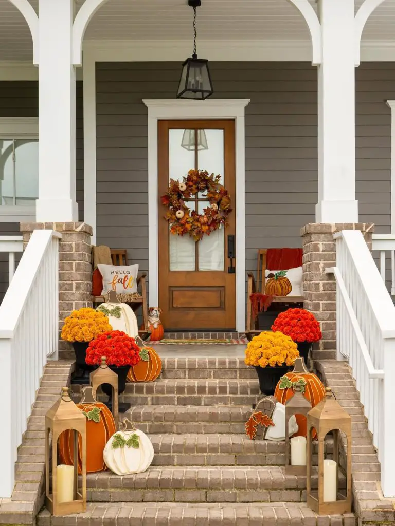 Farmhouse porch with mums lanterns and autumn decorations