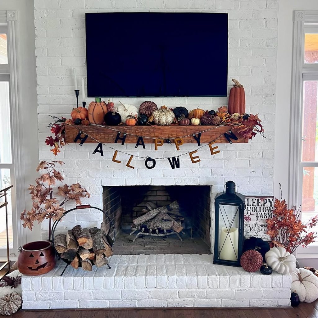 Rustic brick fireplace with harvest pumpkin display and Halloween banner decorations