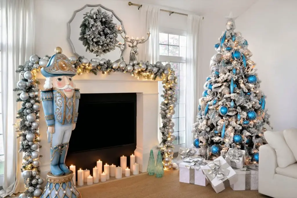 Silver Christmas tree with blue ornaments near decorated fireplace