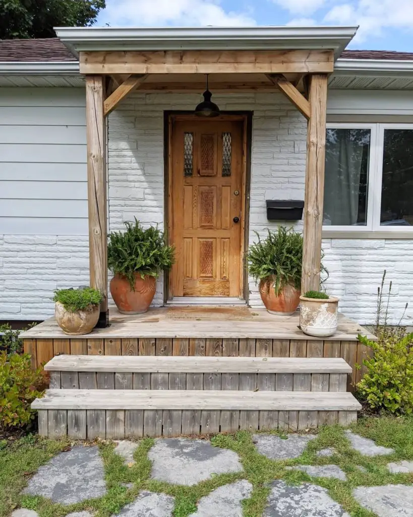 Front entrance with wooden pergola and terra cotta planters