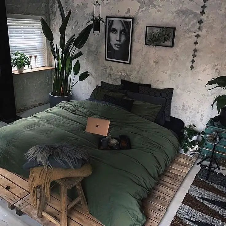 Industrial bedroom with pallet bed and green bedding