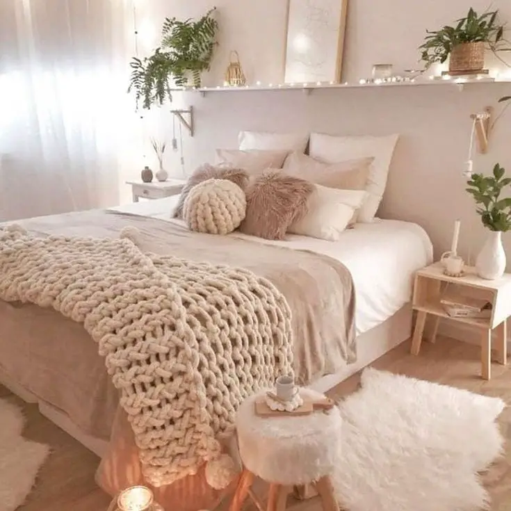 Hygge bedroom with chunky knits and warm lighting