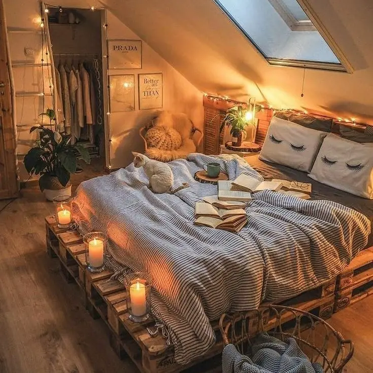 Attic bedroom with candles and pallet bed frame
