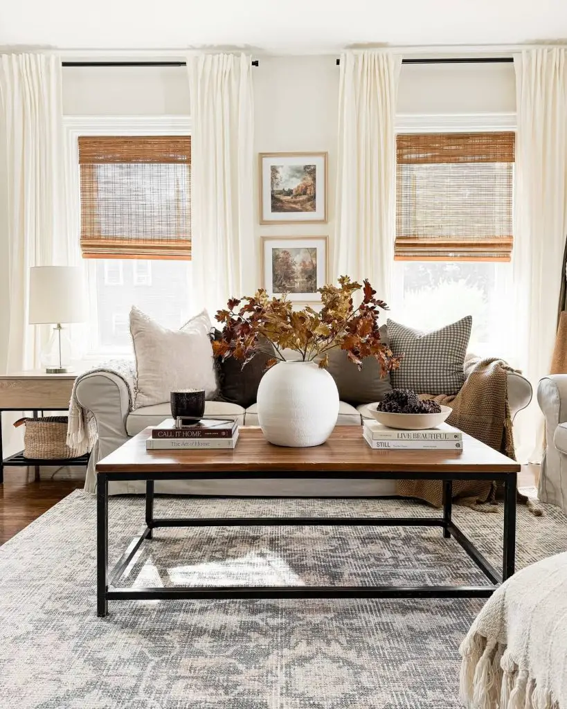 Living room with bamboo shades and autumn branch centerpiece
