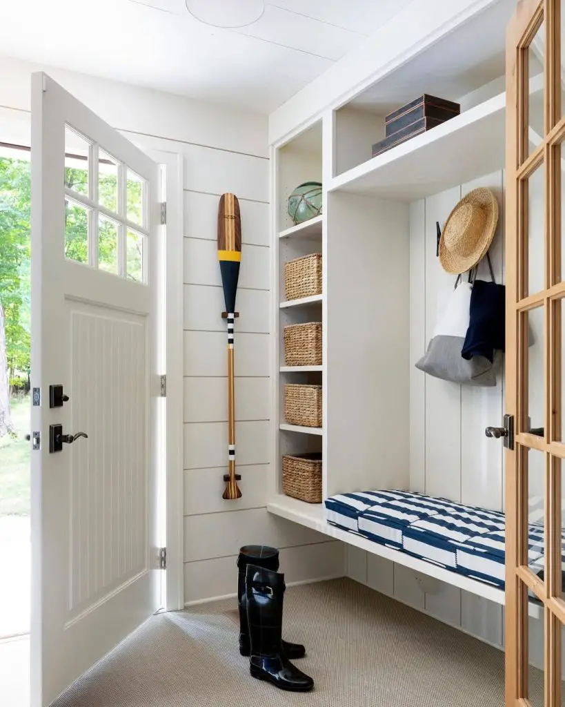 Coastal mudroom with blue stripes, white cabinetry, and nautical accents