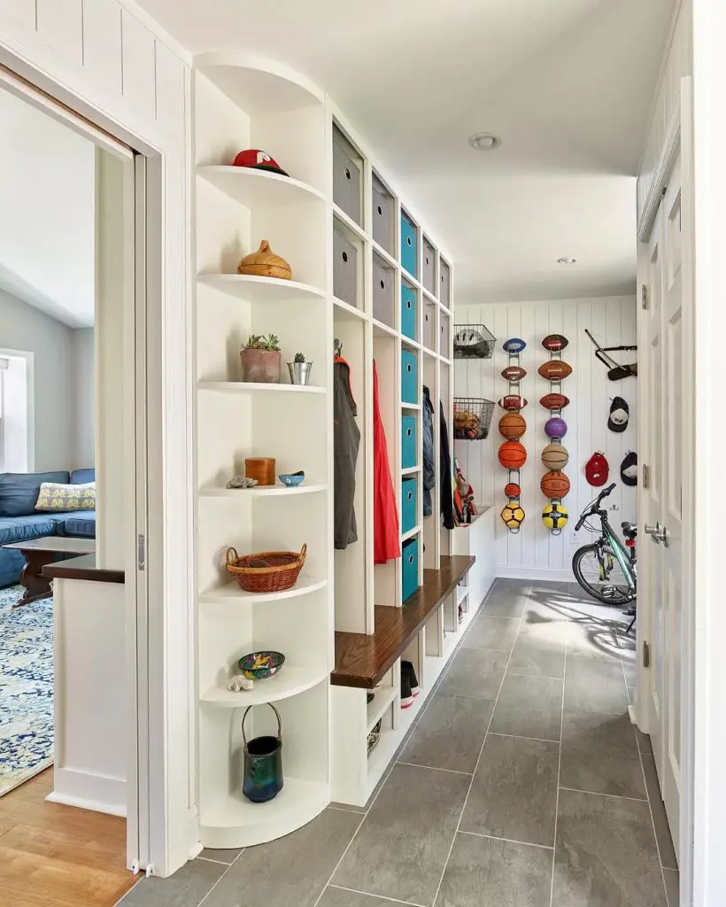 Athletic mudroom with colorful lockers, sports storage, and built-in seating