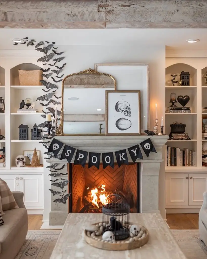 White built-in shelves decorated with Halloween bats spooky banner and seasonal accessories