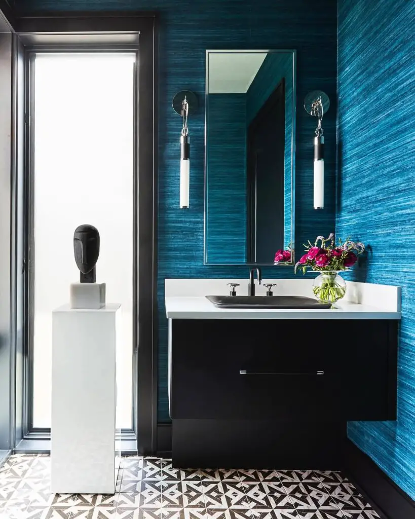 Teal textured powder room with black vanity and geometric floors