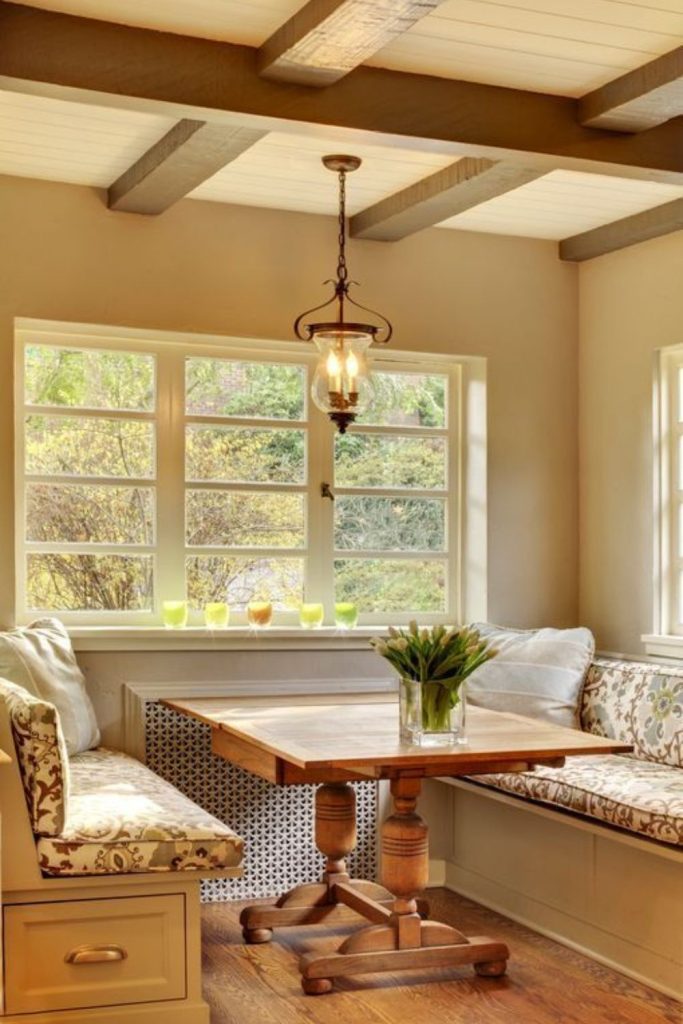 Beamed ceilings with floral cushions.