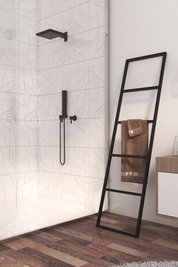 Ladder rack stylishly holds bathroom towels.