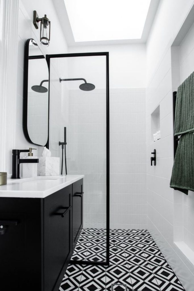 Black monochrome wetroom with bold fixtures