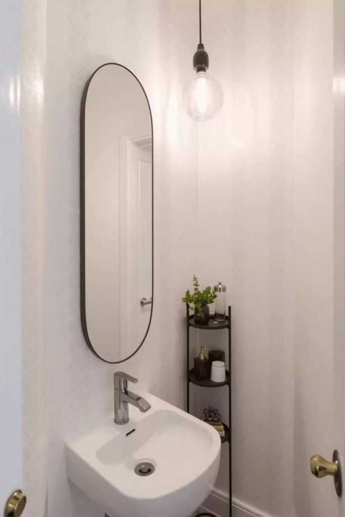 Sleek vertical mirrors enhance narrow toilet