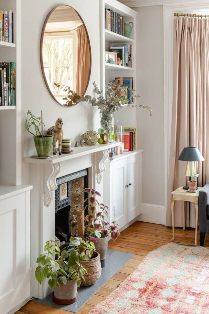 Potted palms with wide mirrored wall.