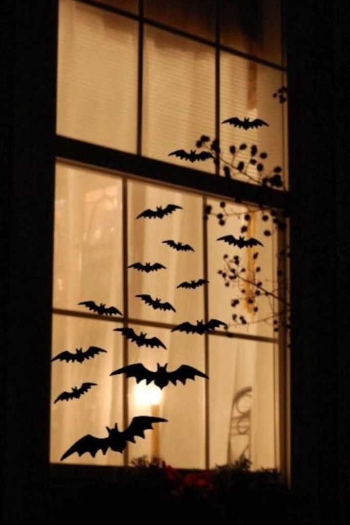 Bat silhouettes flying across glowing moon.