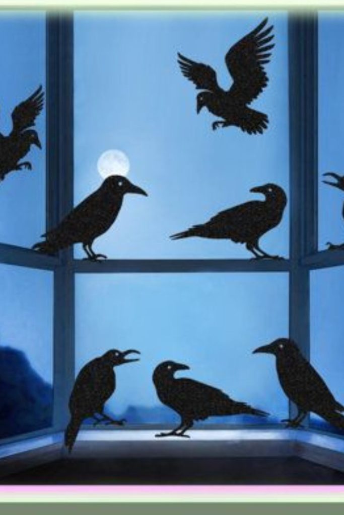 Crow silhouettes perched against moon background.