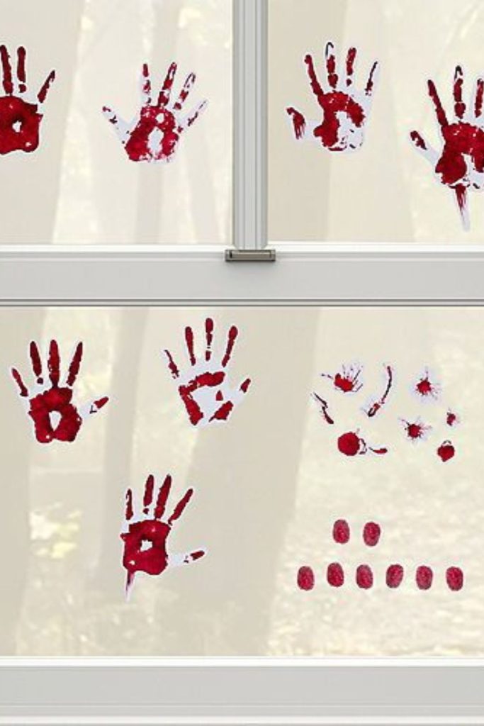 Bloody handprints smeared across window panes.