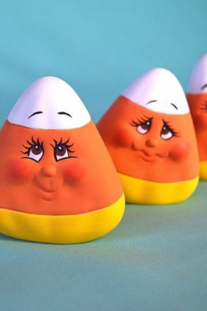 Candy corn clay figures with faces.