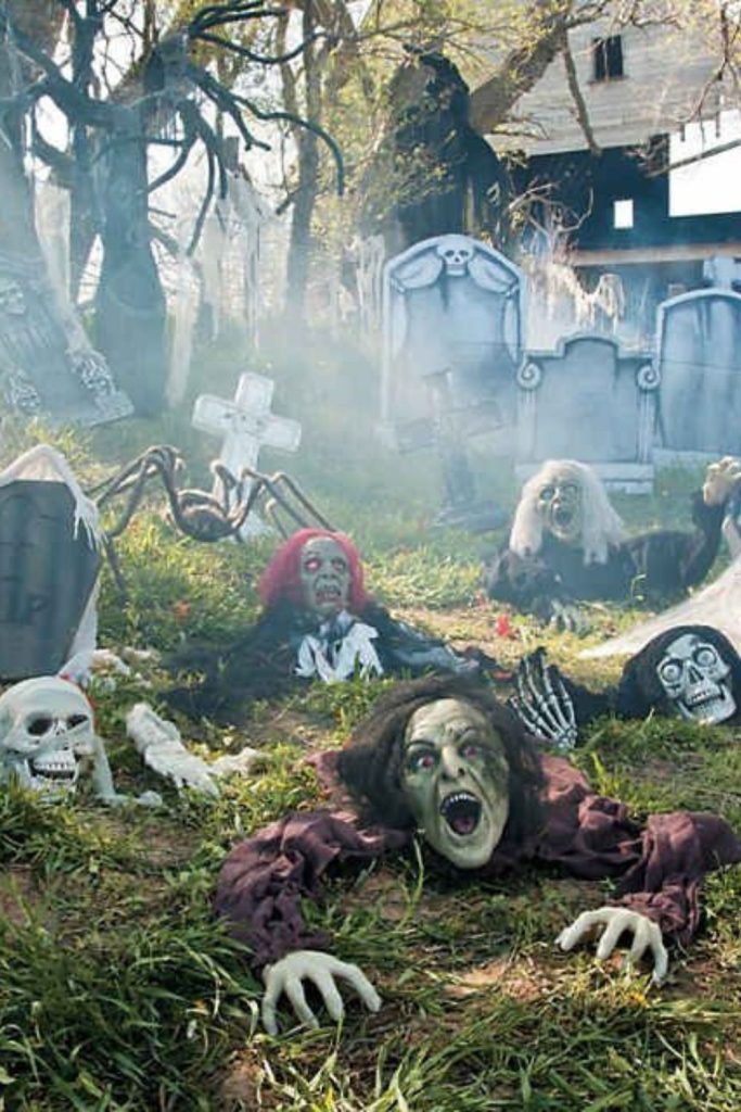 Creepy zombies crawling across haunted lawn