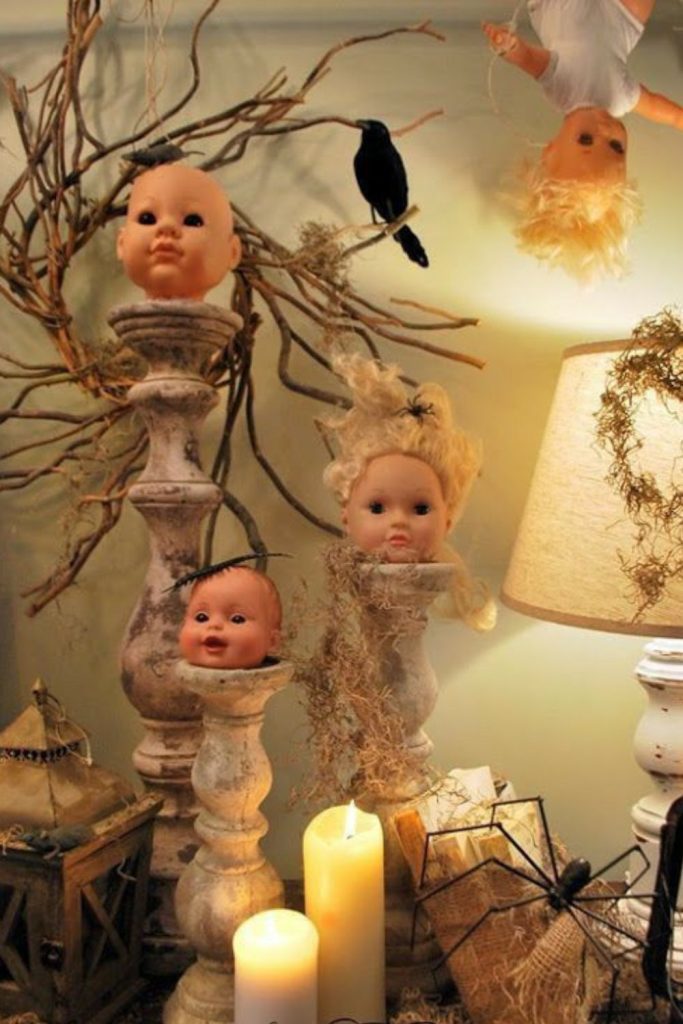 Creepy doll heads displayed across table.