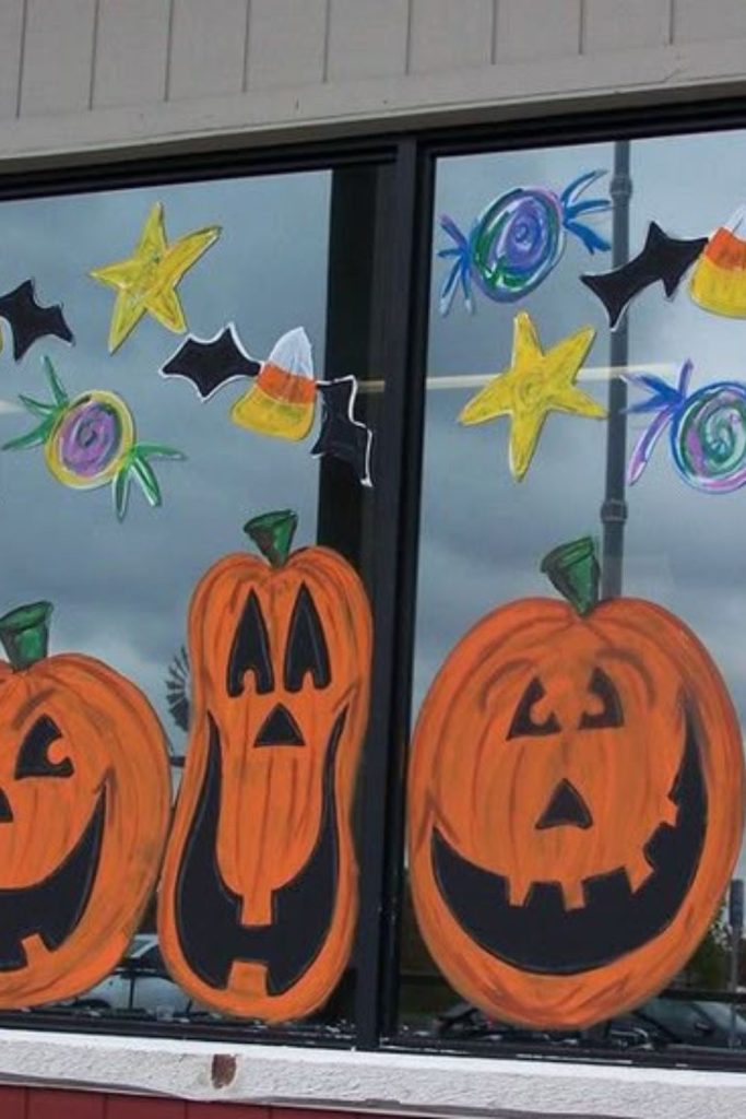 Evil jack-o’-lanterns stacked on window.