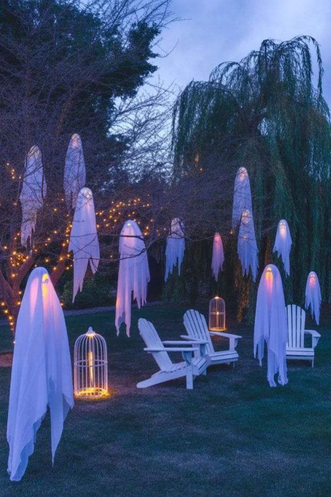 Floating ghost sheets glowing in yard