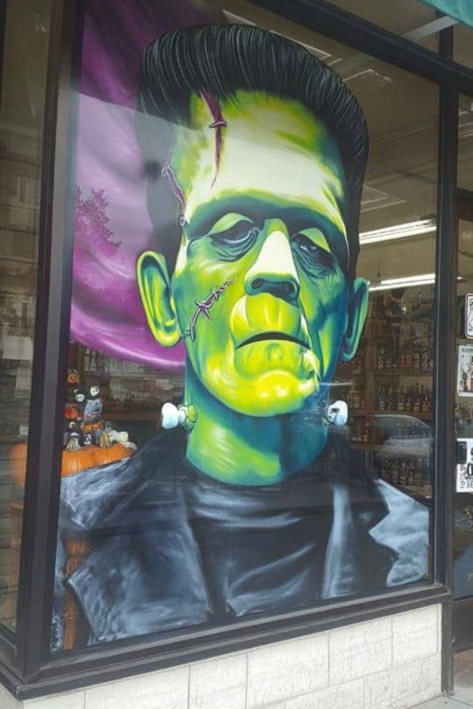 Frankenstein’s monster painted green on window.