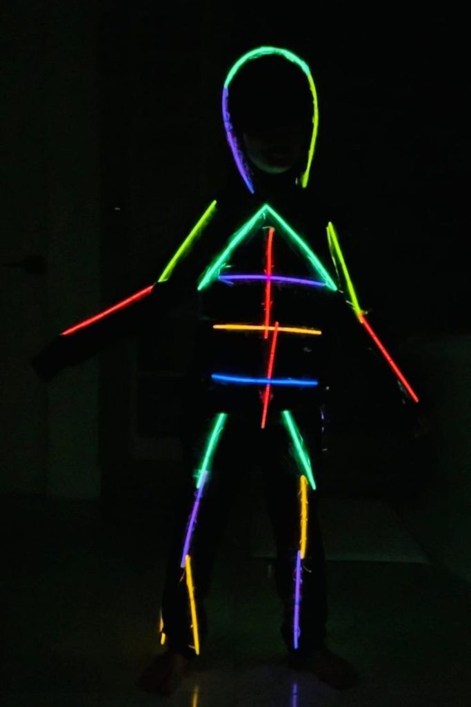Glowing skeleton shapes made from sticks.
