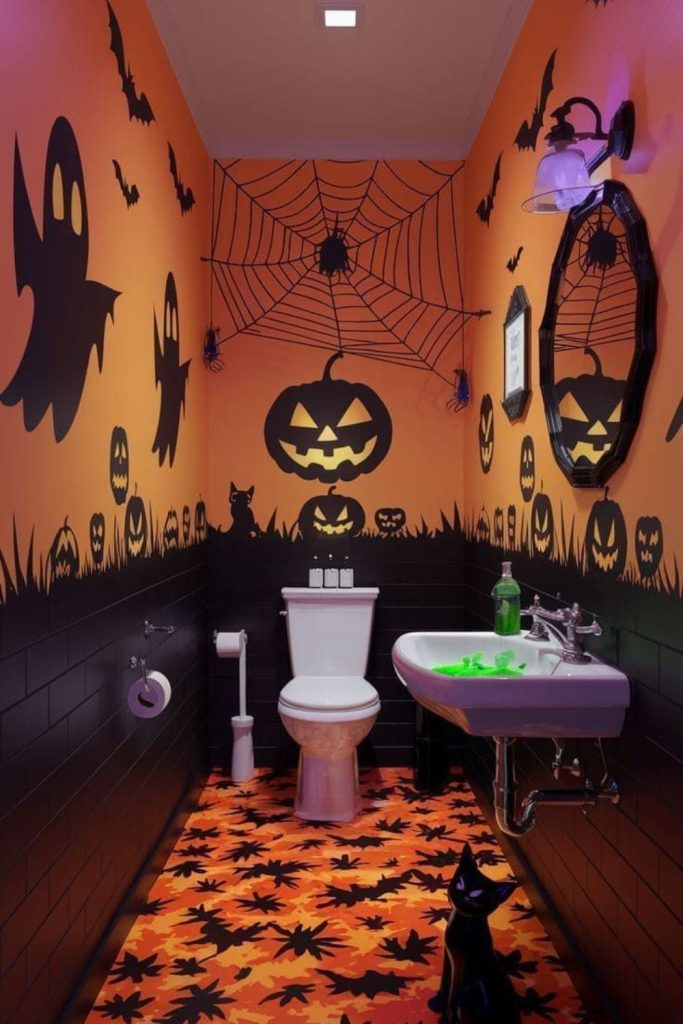 Orange and black Halloween bathroom with ghosts, bats, and pumpkins.