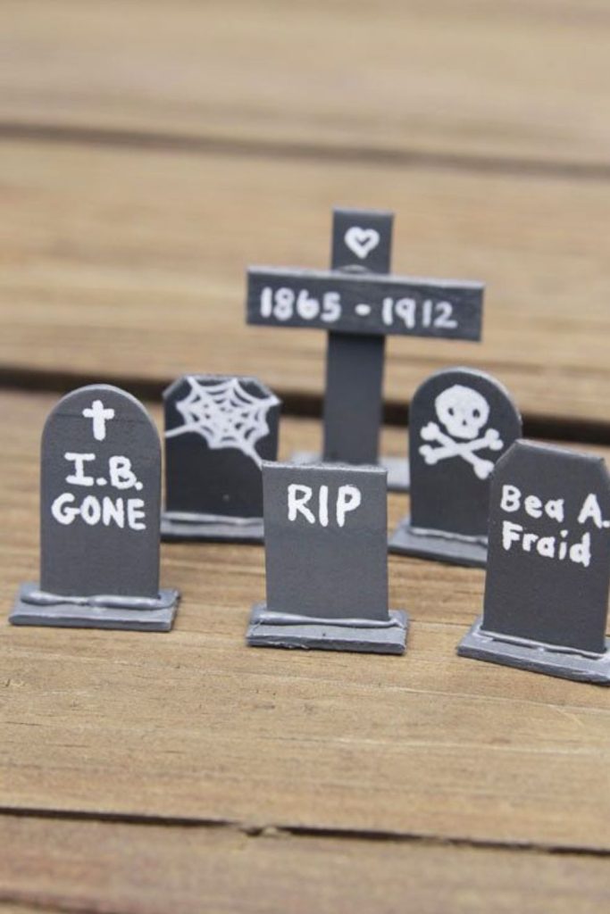 Mini cardboard tombstones with spooky names.