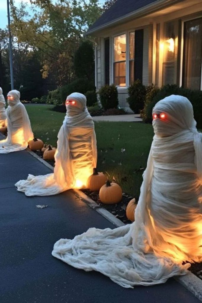Mummy statue guarding spooky front yard entrance