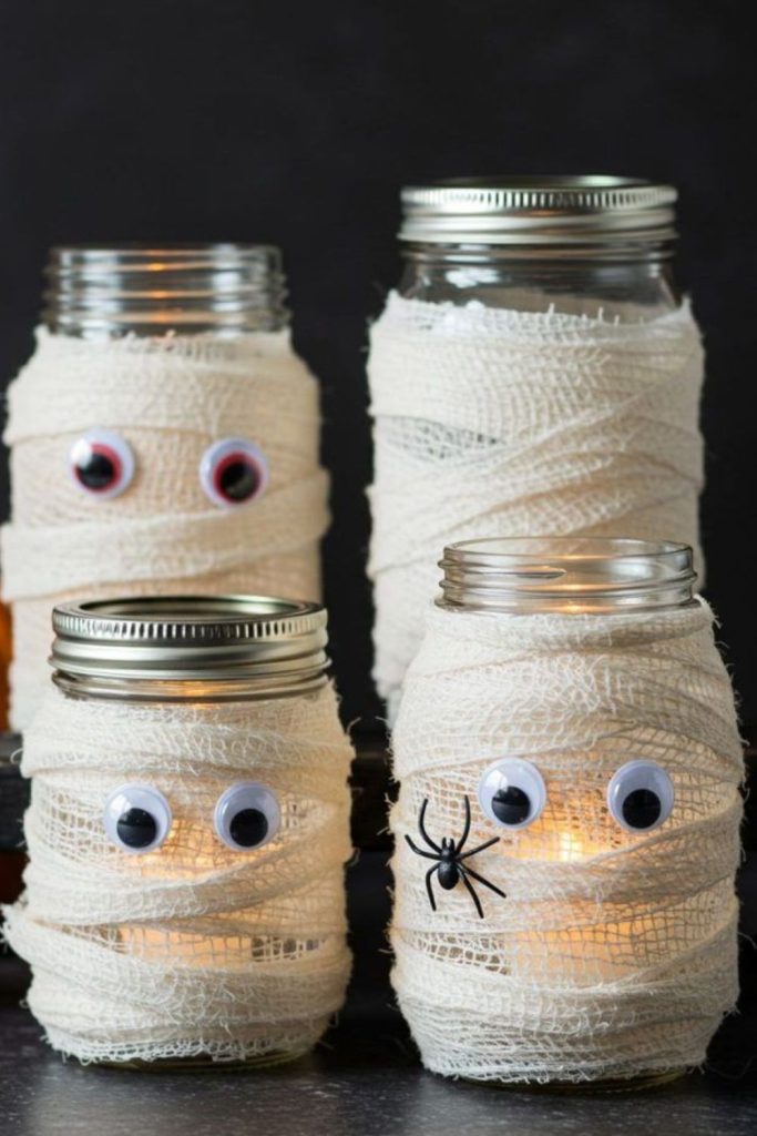 Mason jar mummies with glowing eyes.