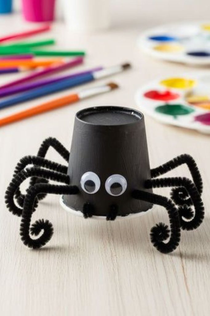 Black paper cup spiders with legs.