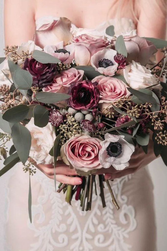 Plum roses with moody eucalyptus arrangement