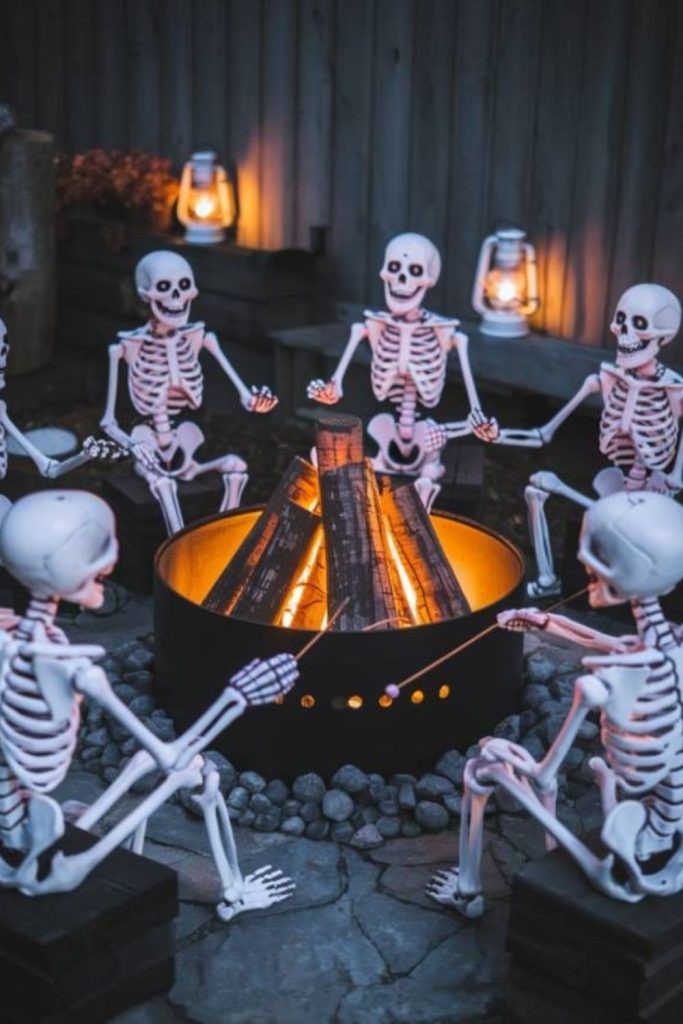 Skeleton relaxing by bonfire in yard
