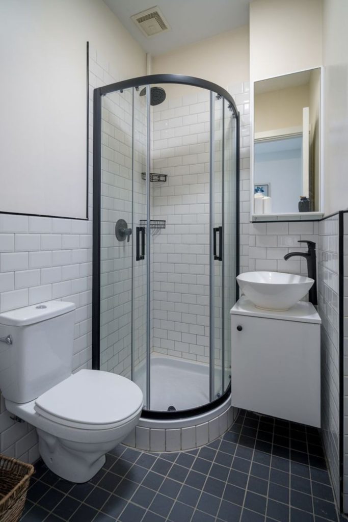 Monochrome sleek compact bathroom with symmetry.
